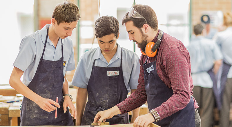Gilroy Catholic College Castle Hill teacher teaching woodwork to VET students