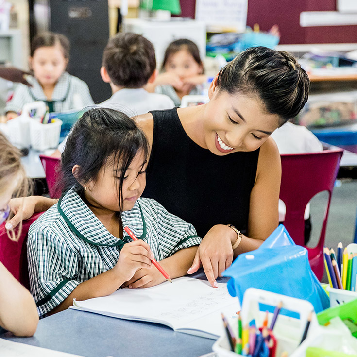 Catholic Schools Parramatta Diocese teacher assisting students in class