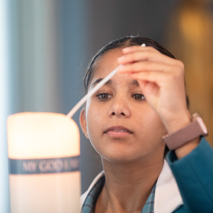 Catherine McAUley Westmead student lighting candle